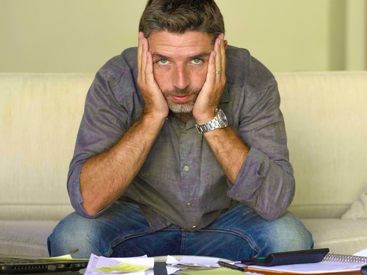 Stressed man going over finances.