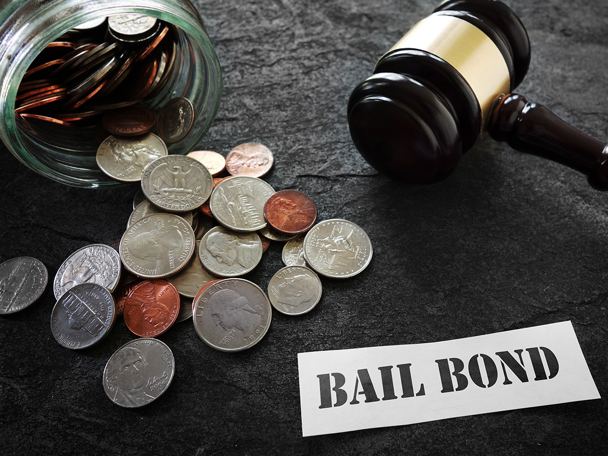 Money and gavel with paper that reads “bail bonds.”