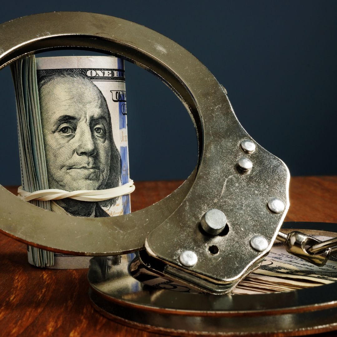 Image of cash and handcuffs