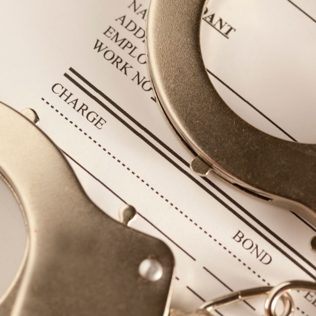 Handcuffs on top of bail bond paperwork