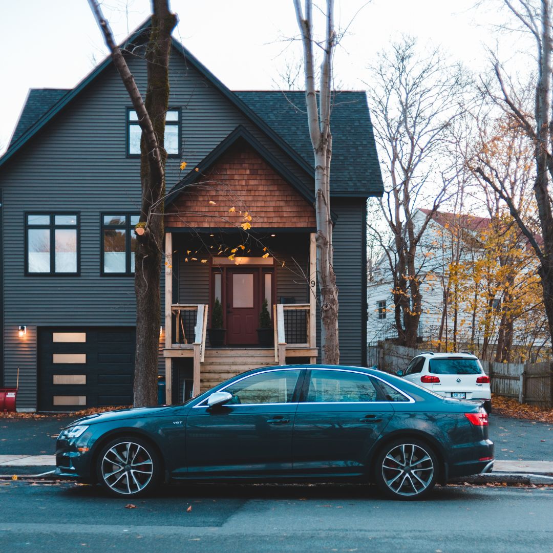 2 cars parked in front of a house