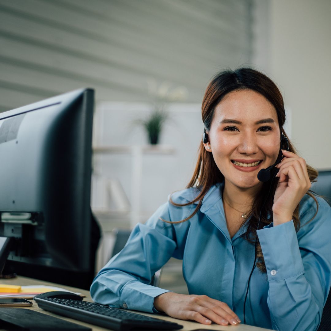 a worker in an office on a call in front of a computer