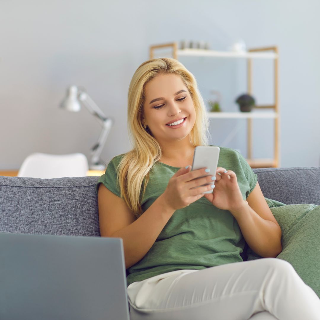 a woman on her cellphone on her couch