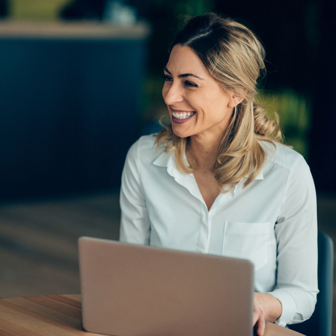 Woman with laptop smiling