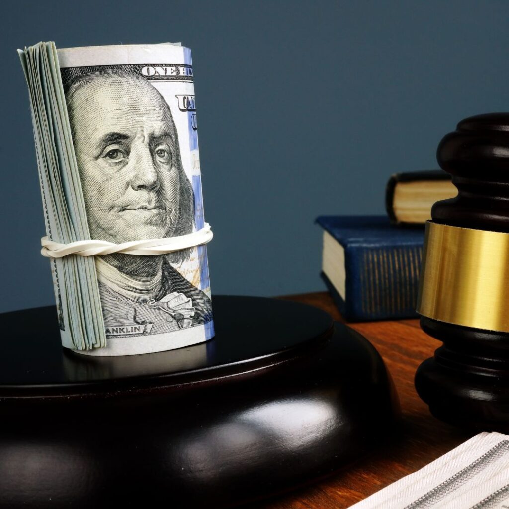 a roll of money on a gavel stand by a gavel