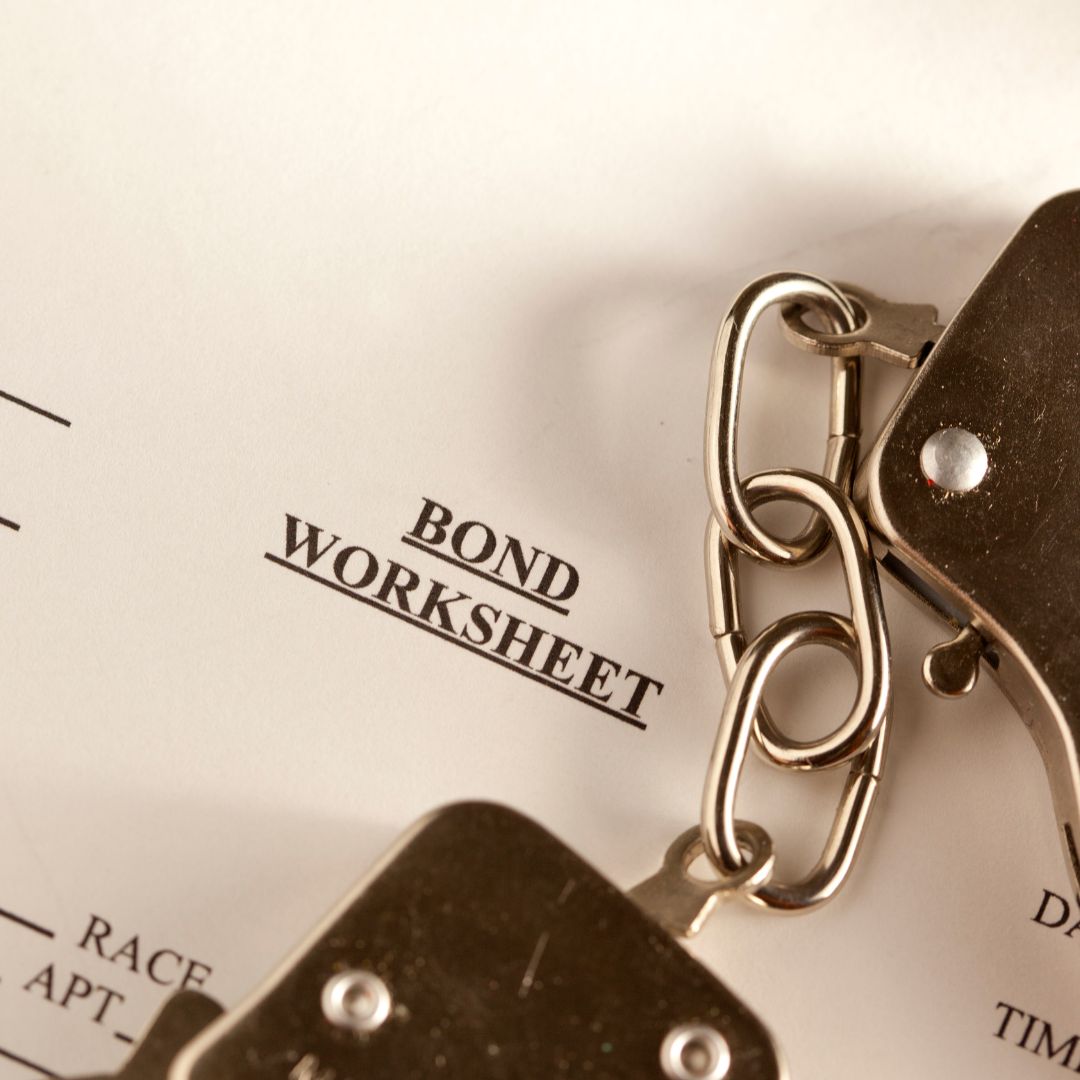 bail bond worksheet and handcuffs