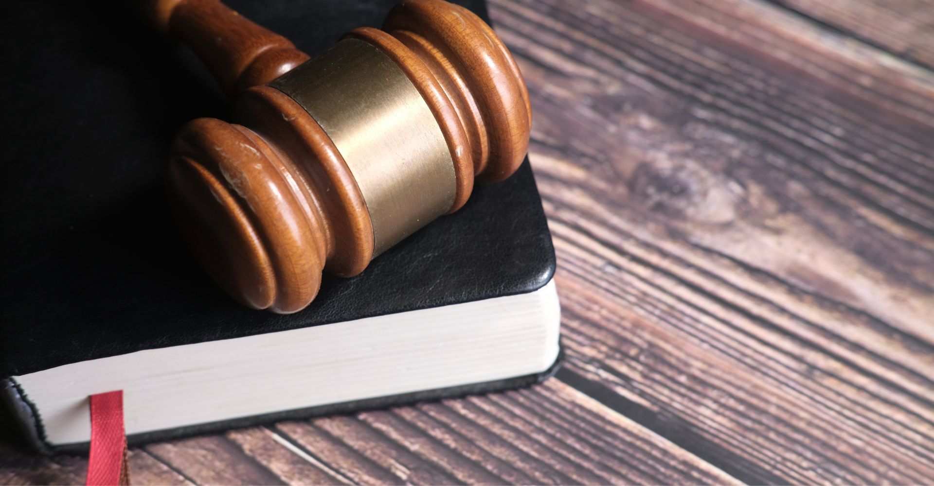 Wooden gavel resting on a closed book
