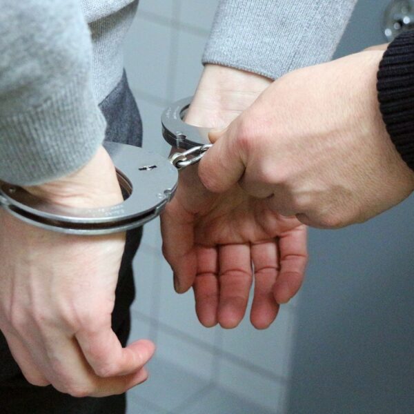 person in handcuffs