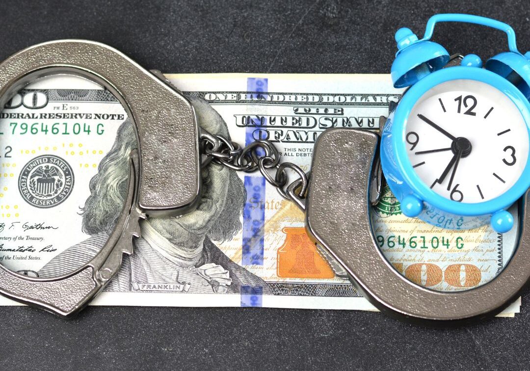 money, handcuffs, and a clock